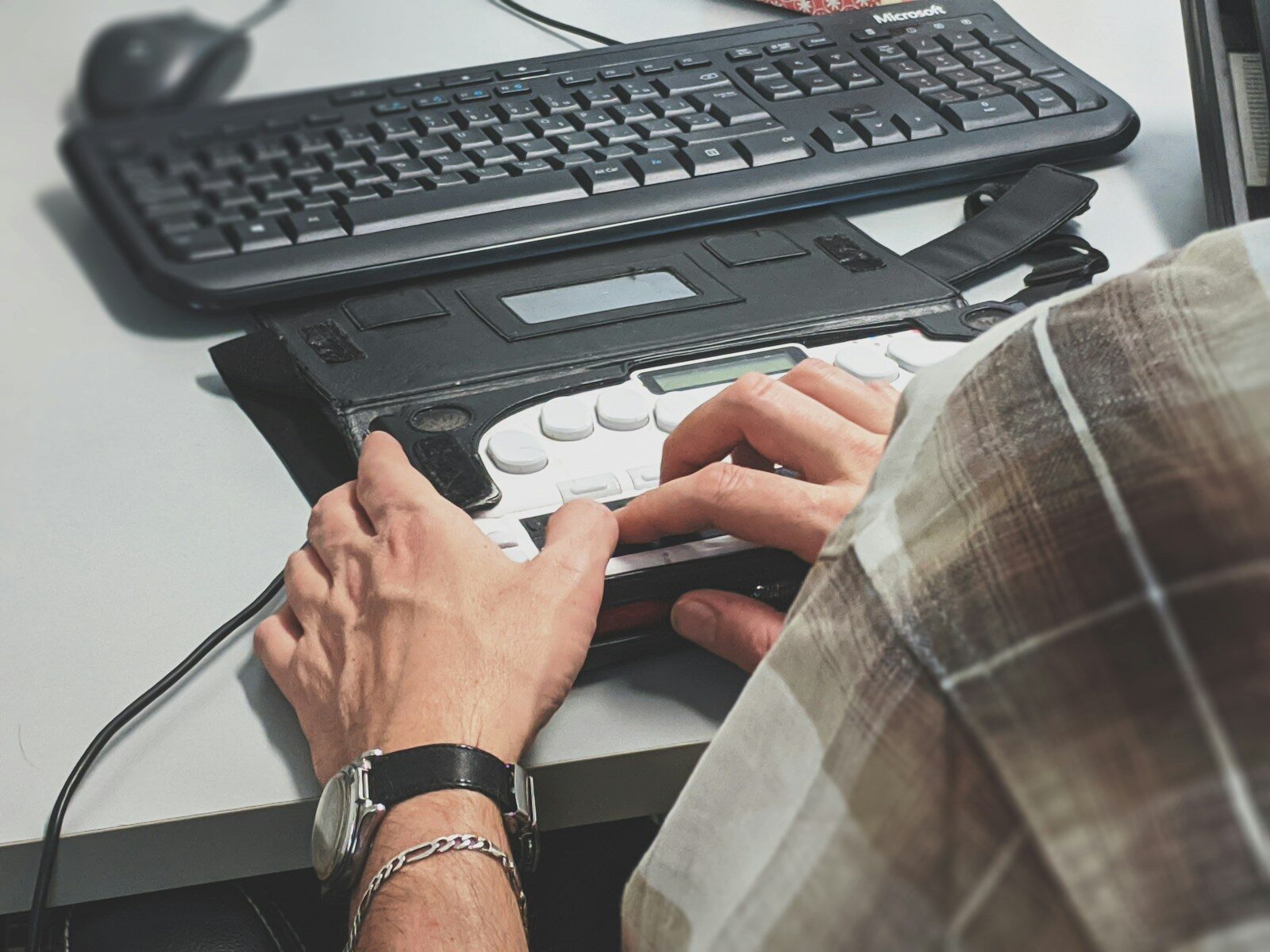 person using braille writer